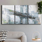 Three-panel canvas wall art featuring urban cityscape with architectural forms, displayed in a modern living room above a sofa.