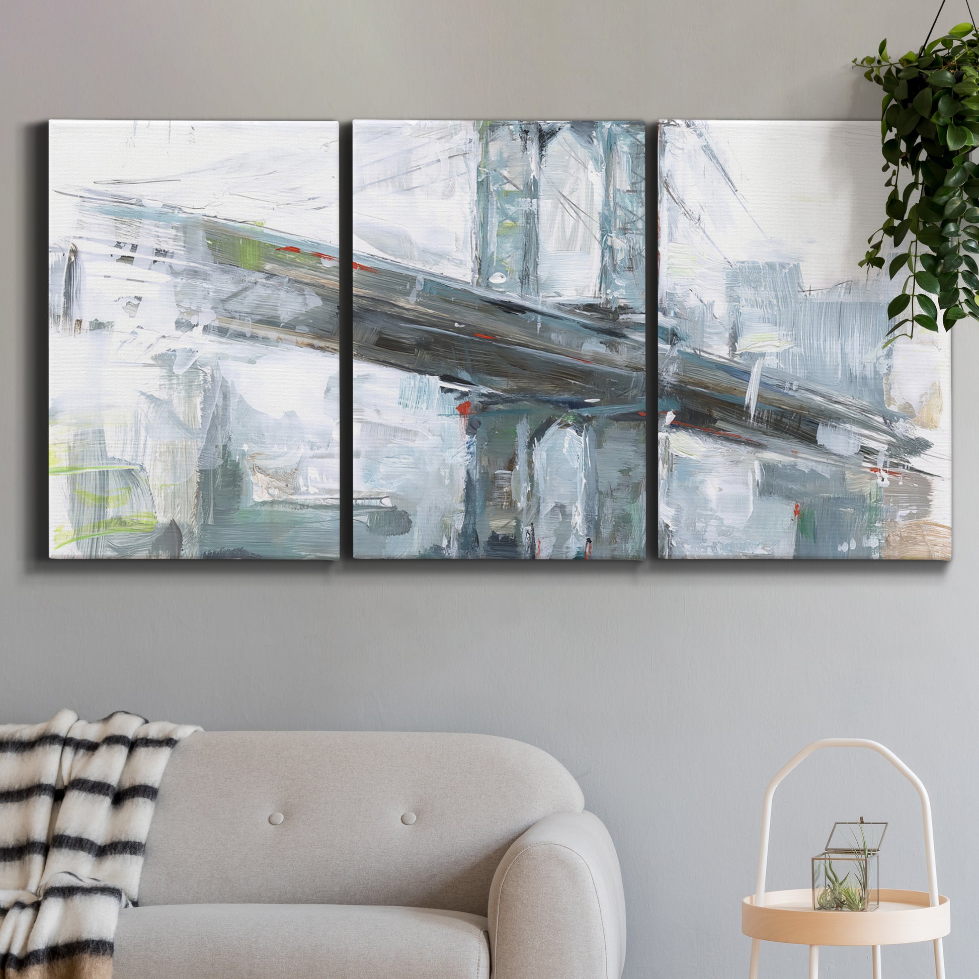 Three-panel canvas wall art featuring urban cityscape with architectural forms, displayed in a modern living room above a sofa.