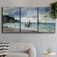 Three-panel canvas wall art featuring figures walking along sandy shoreline, displayed in a modern living room above a sofa.