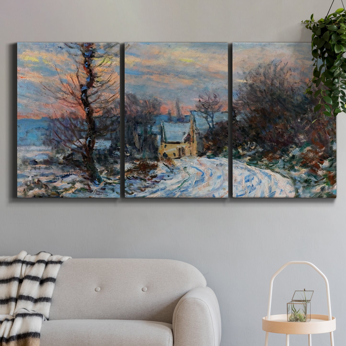Three-panel canvas wall art featuring snow covered road leading to village, displayed in a modern living room above a sofa.