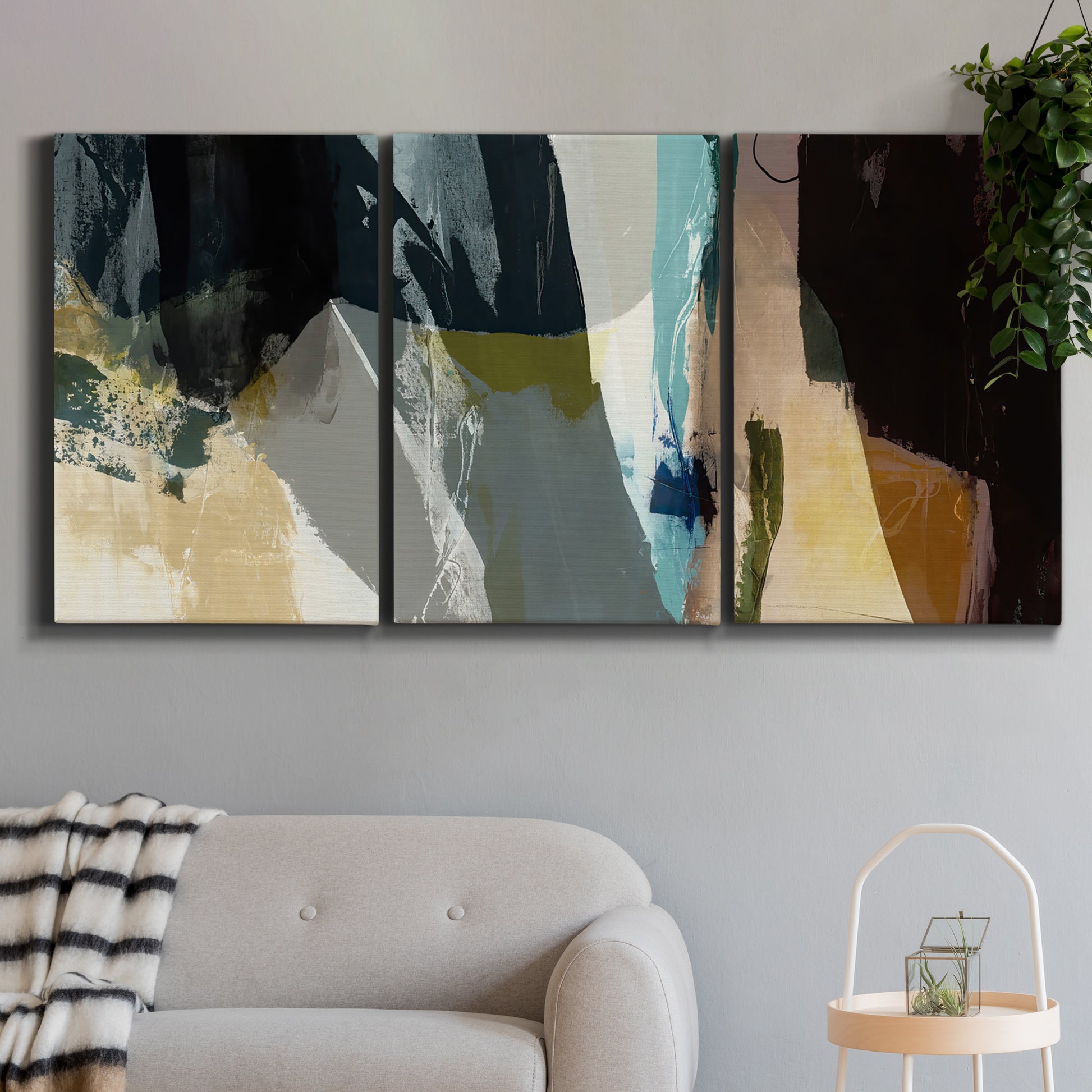 Three-panel canvas wall art featuring layered neutral abstract textures, displayed in a modern living room above a sofa.