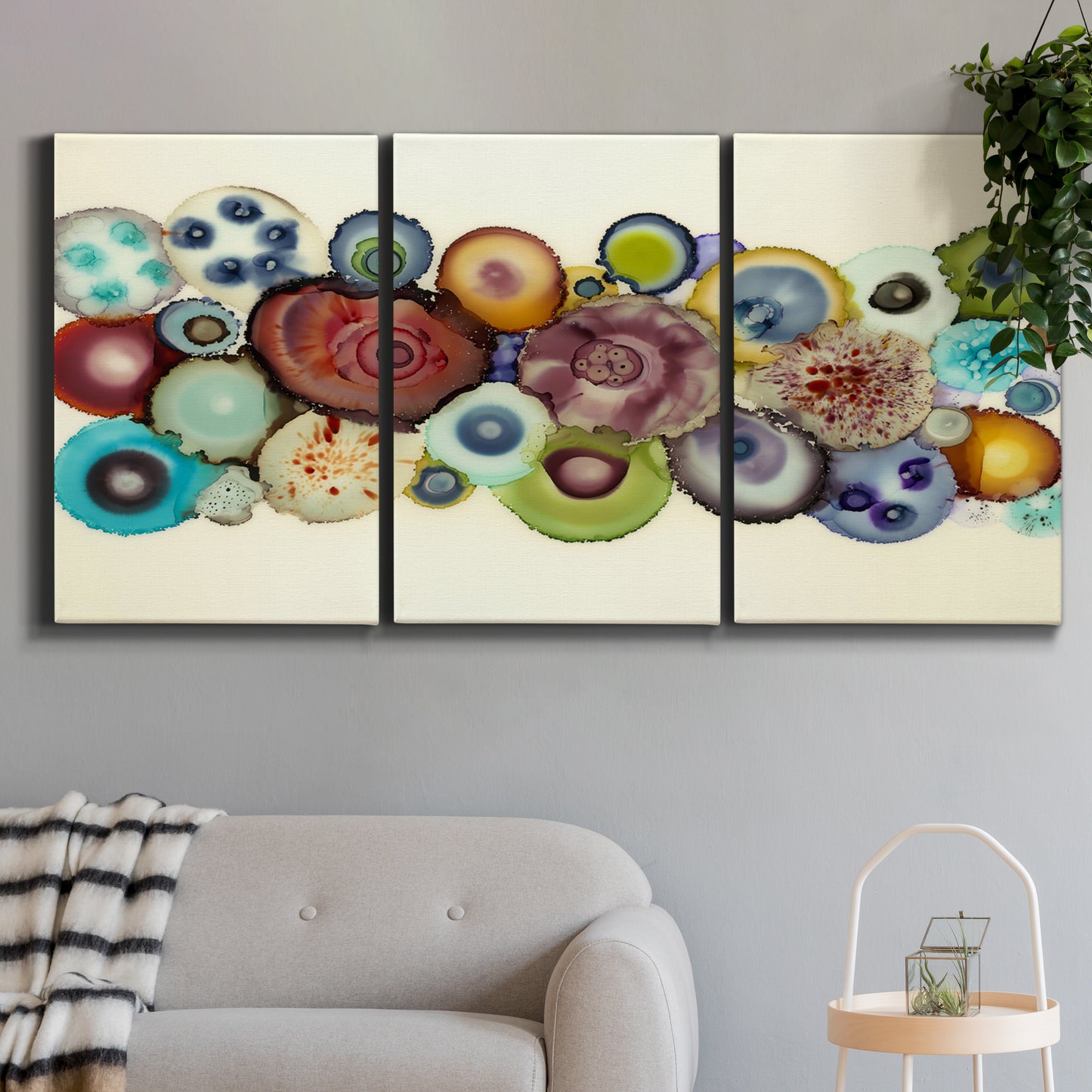 Three-panel canvas wall art featuring mid century geometric red pathway, displayed in a modern living room above a sofa.
