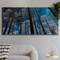 Three-panel canvas wall art featuring night landscape silhouette photography, displayed in a modern living room above a sofa.