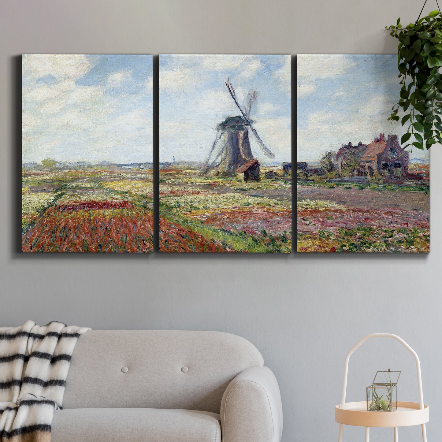 Three-panel canvas wall art featuring tulip fields with windmill, displayed in a modern living room above a sofa.