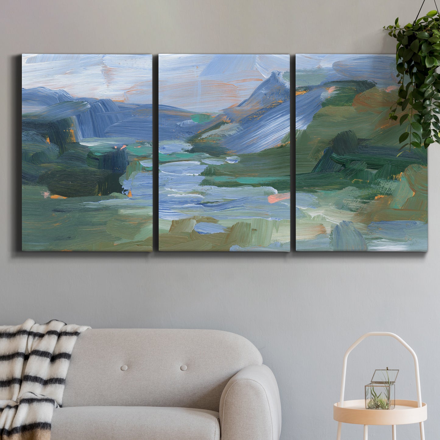 Three-panel canvas wall art featuring abstract landscape composition study, displayed in a modern living room above a sofa.