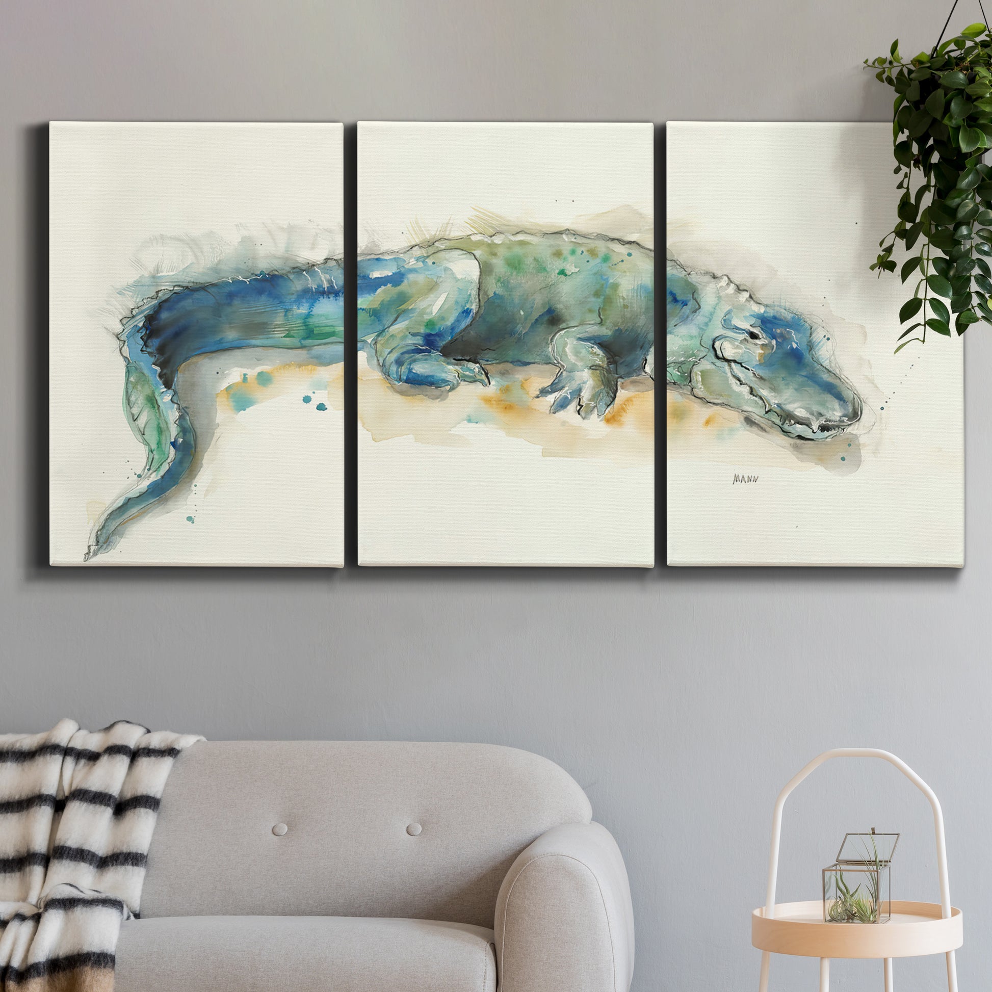 Three-panel canvas wall art featuring alligator illustrated wildlife portrait, displayed in a modern living room above a sofa.