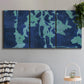 Three-panel canvas wall art featuring abstract floral shapes, displayed in a modern living room above a sofa.