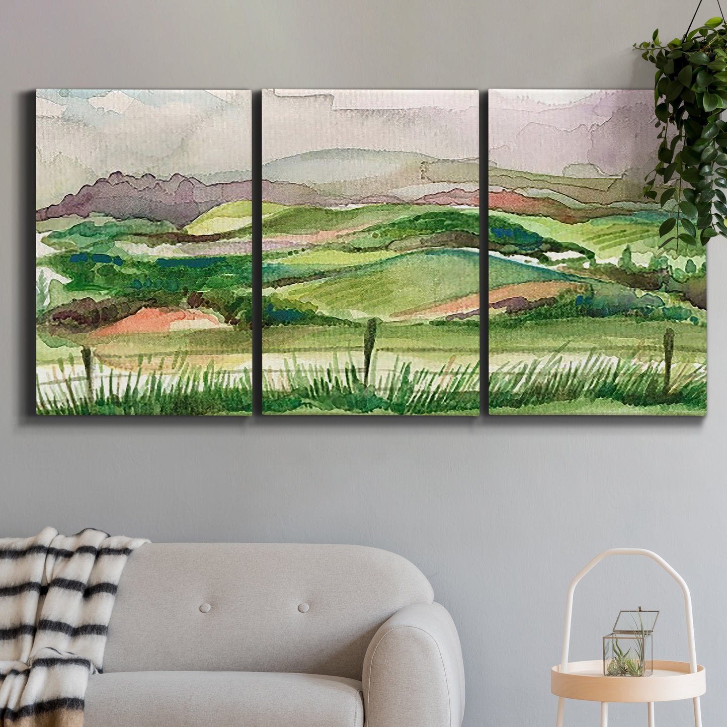 Three-panel canvas wall art featuring rainy landscape with soft atmosphere, displayed in a modern living room above a sofa.