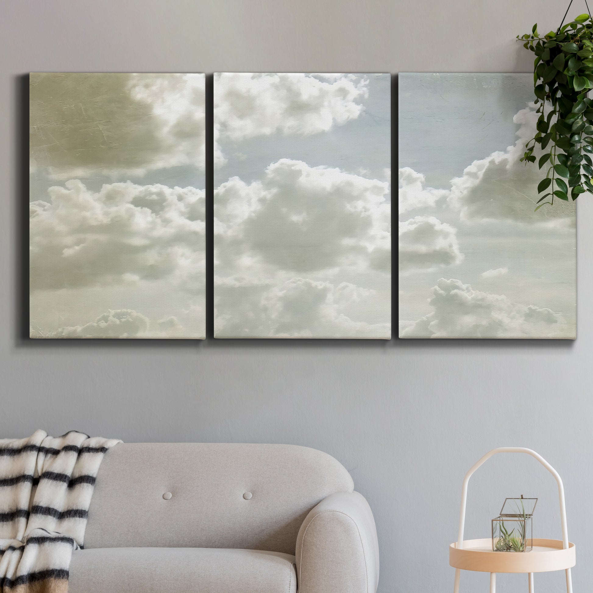 Three-panel canvas wall art featuring whimsical vertical tree landscape, displayed in a modern living room above a sofa.