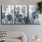 Three-panel canvas wall art featuring indigo floral abstraction, displayed in a modern living room above a sofa.