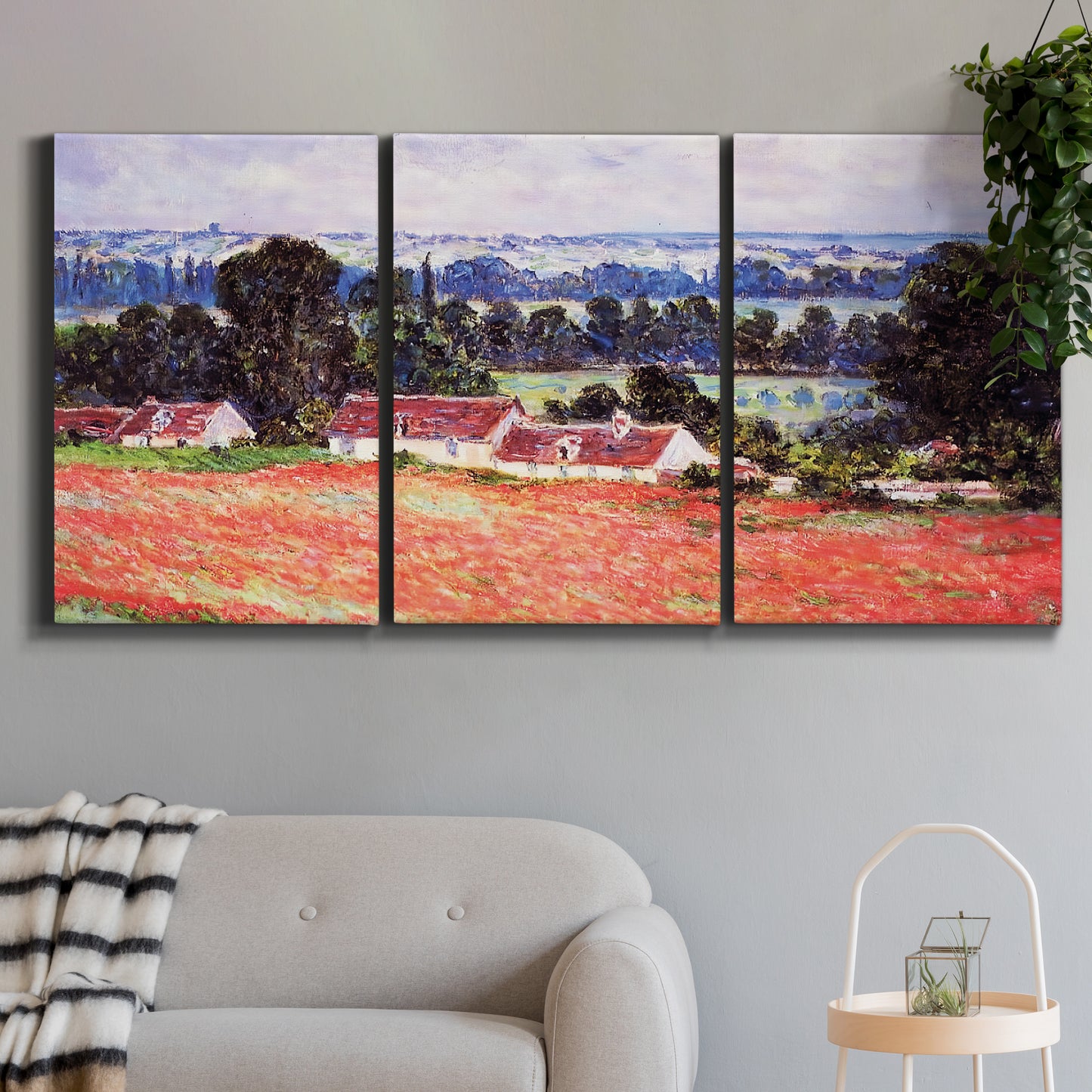 Three-panel canvas wall art featuring poppy field at giverny in bloom, displayed in a modern living room above a sofa.