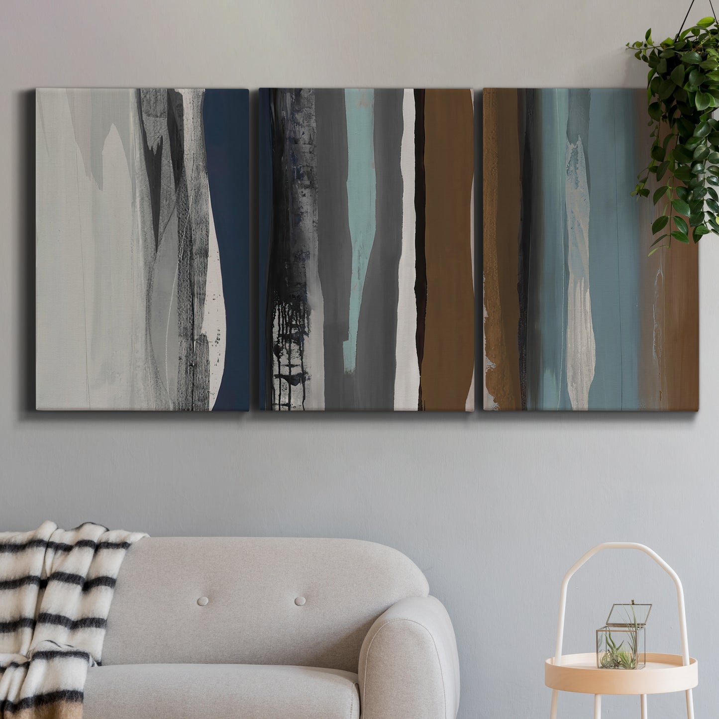Three-panel canvas wall art featuring layered abstract amusement park tones, displayed in a modern living room above a sofa.