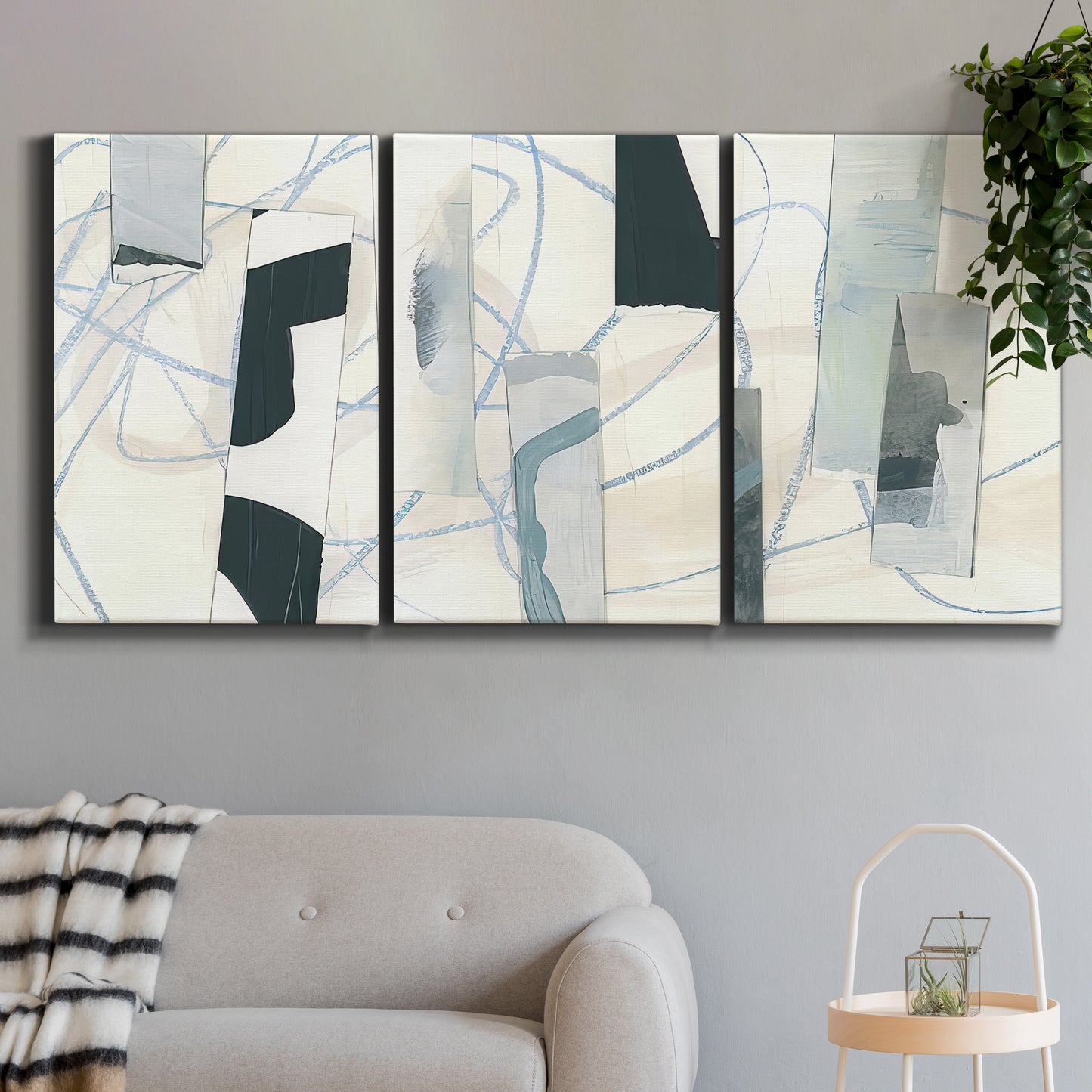 Three-panel canvas wall art featuring interwoven icy abstract linear forms, displayed in a modern living room above a sofa.