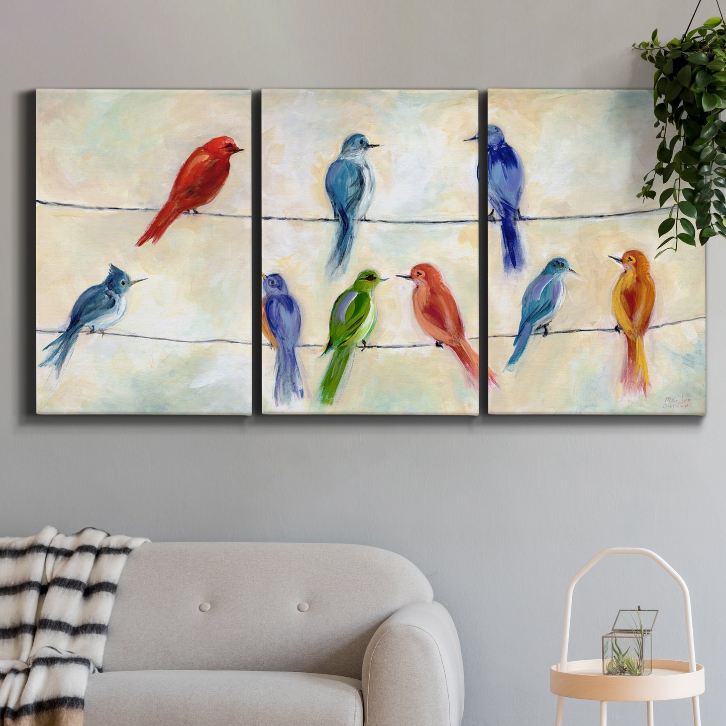 Three-panel canvas wall art featuring whimsical animal chatter illustration, displayed in a modern living room above a sofa.