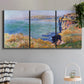 Three-panel canvas wall art featuring coastal village view near dieppe, displayed in a modern living room above a sofa.