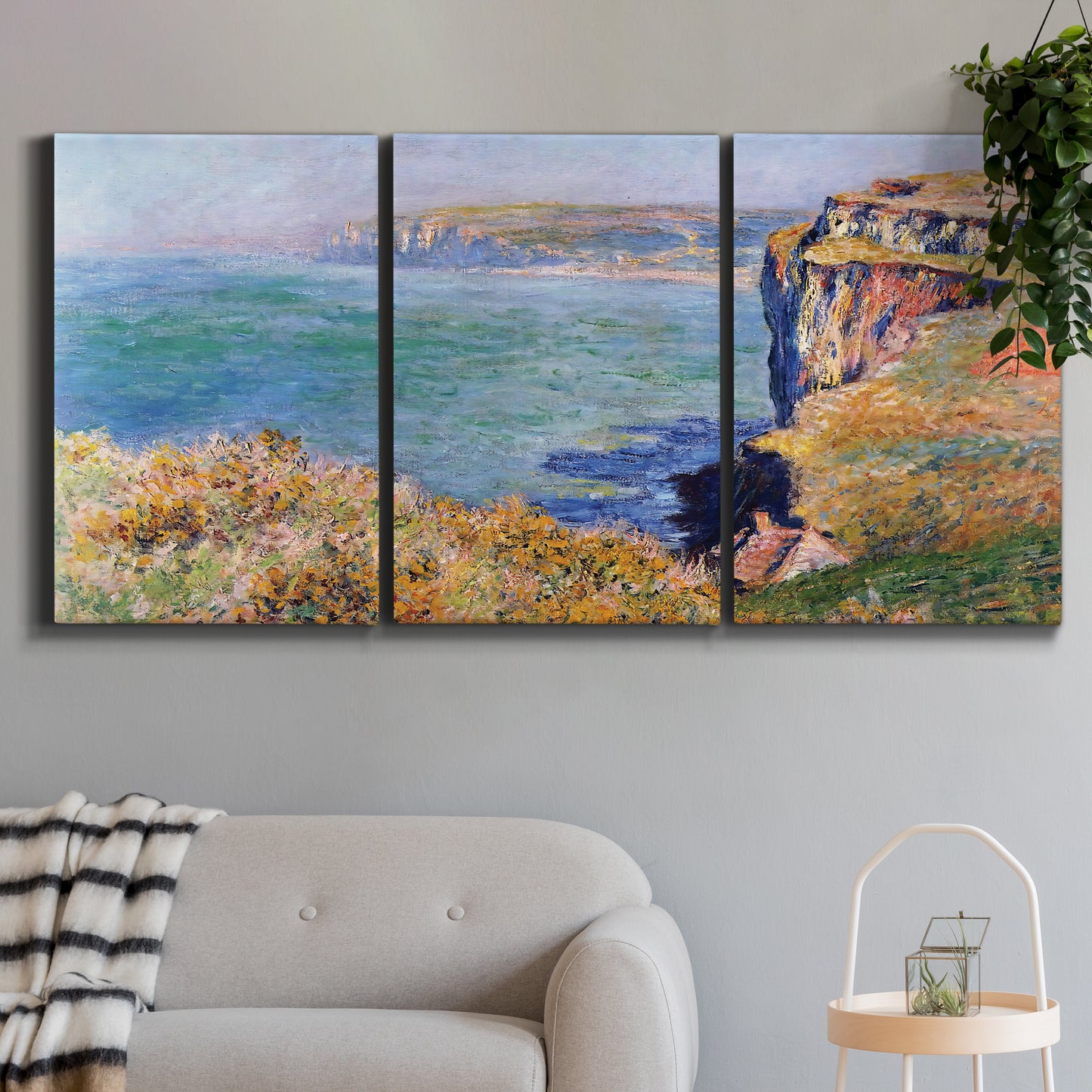 Three-panel canvas wall art featuring coastal village view near dieppe, displayed in a modern living room above a sofa.