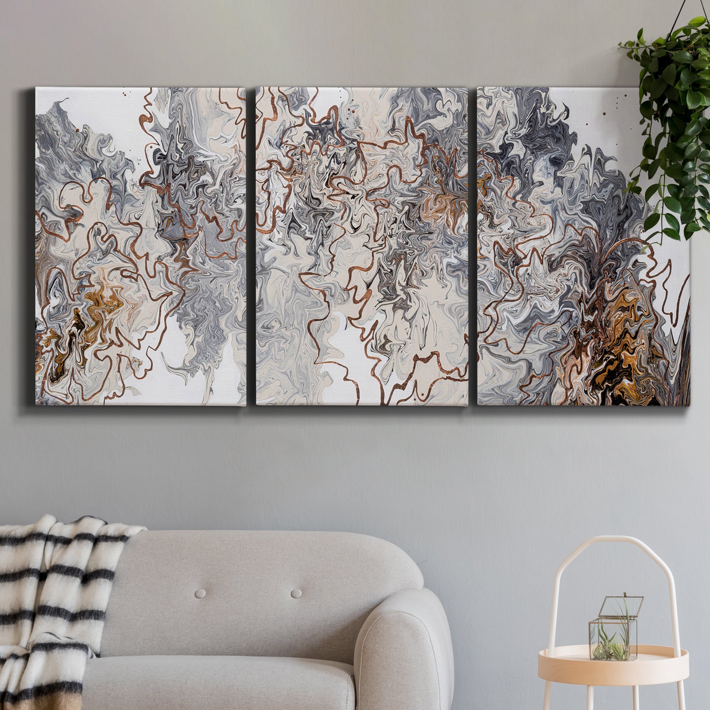 Three-panel canvas wall art featuring wooded trail through forest, displayed in a modern living room above a sofa.