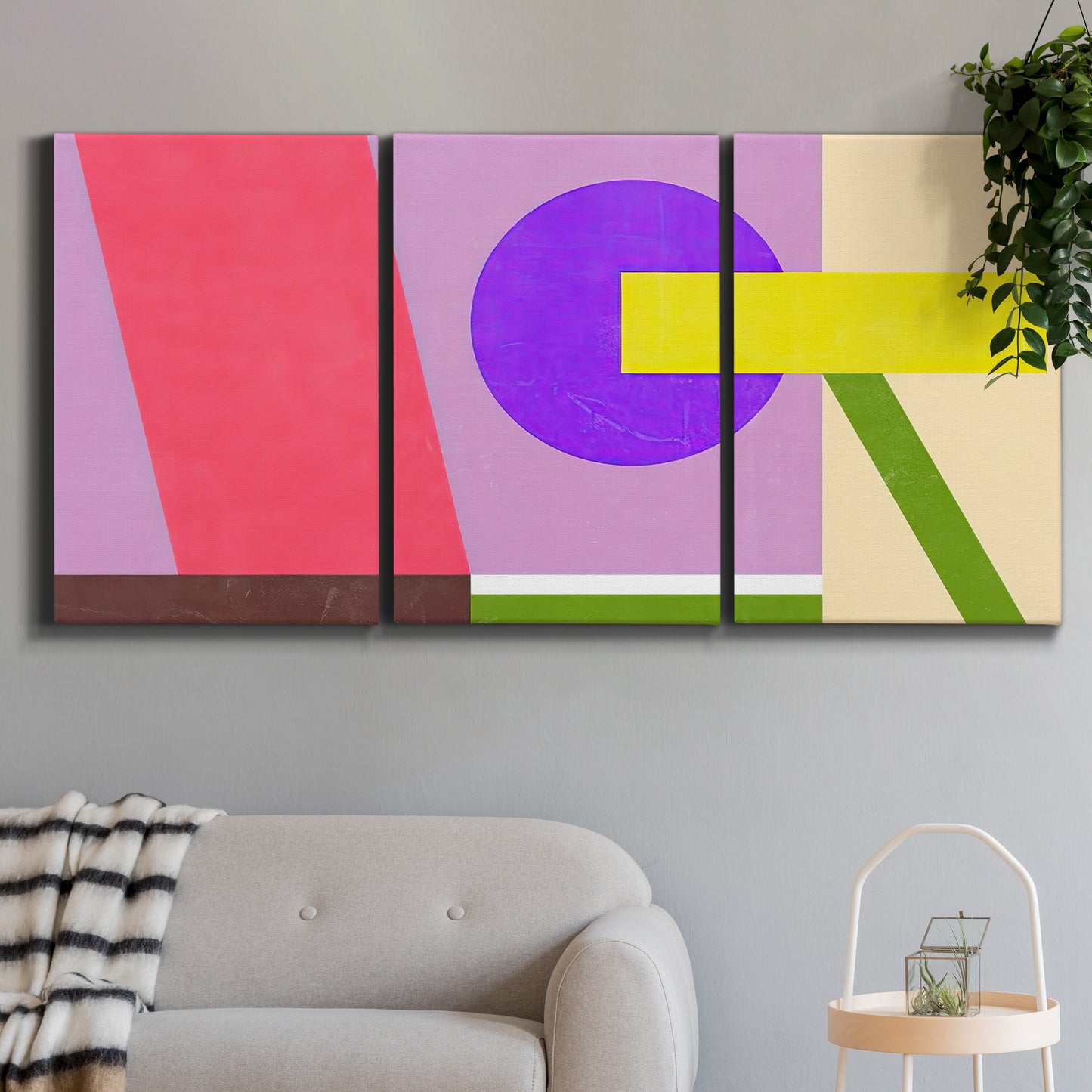 Three-panel canvas wall art featuring bold geometric color abstraction, displayed in a modern living room above a sofa.