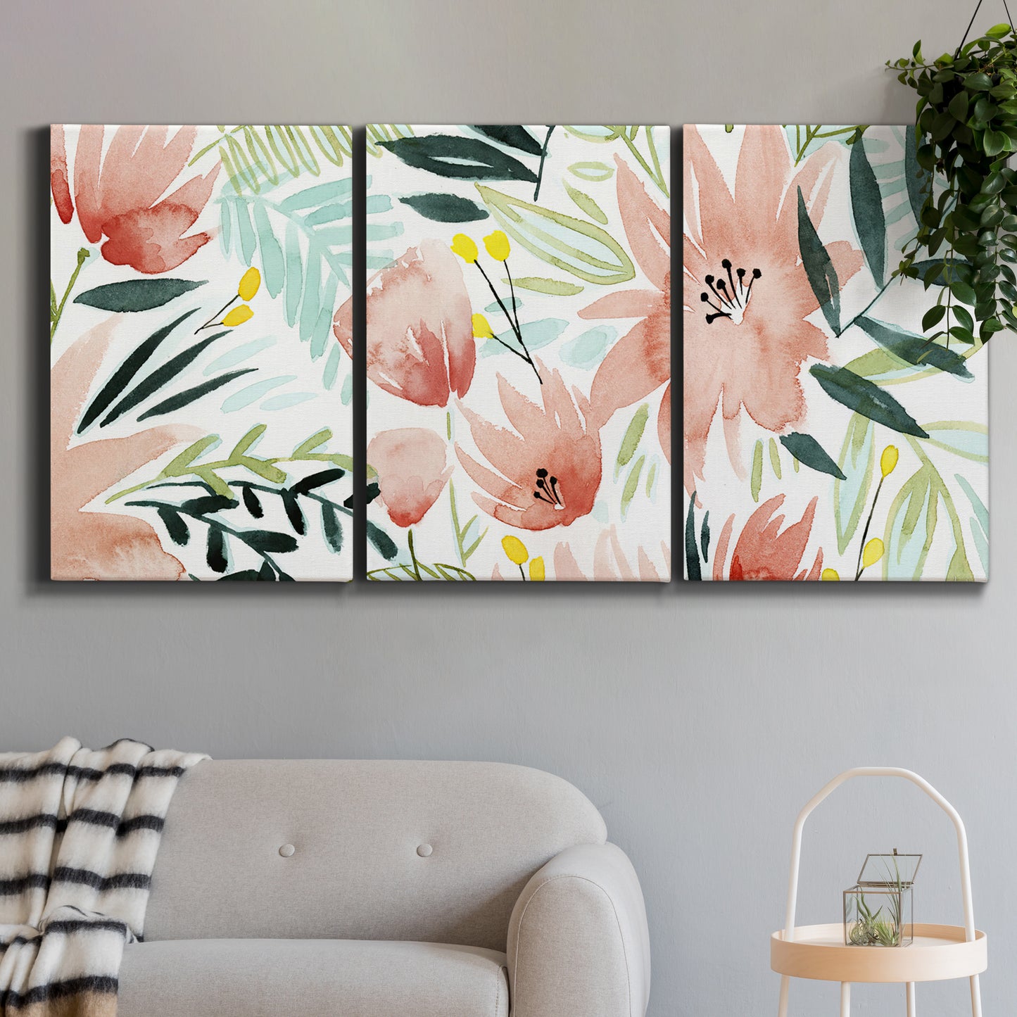 Three-panel canvas wall art featuring layered tropical plant collage, displayed in a modern living room above a sofa.
