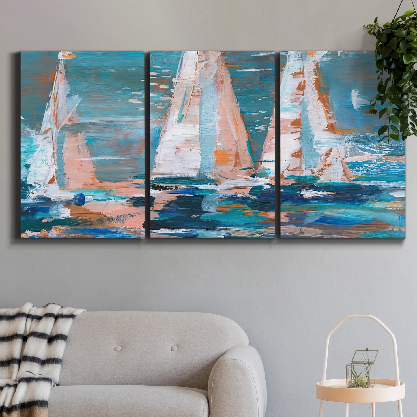 Three-panel canvas wall art featuring graphic pop style sailboats, displayed in a modern living room above a sofa.