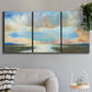 Three-panel canvas wall art featuring dawn light breaking over water, displayed in a modern living room above a sofa.
