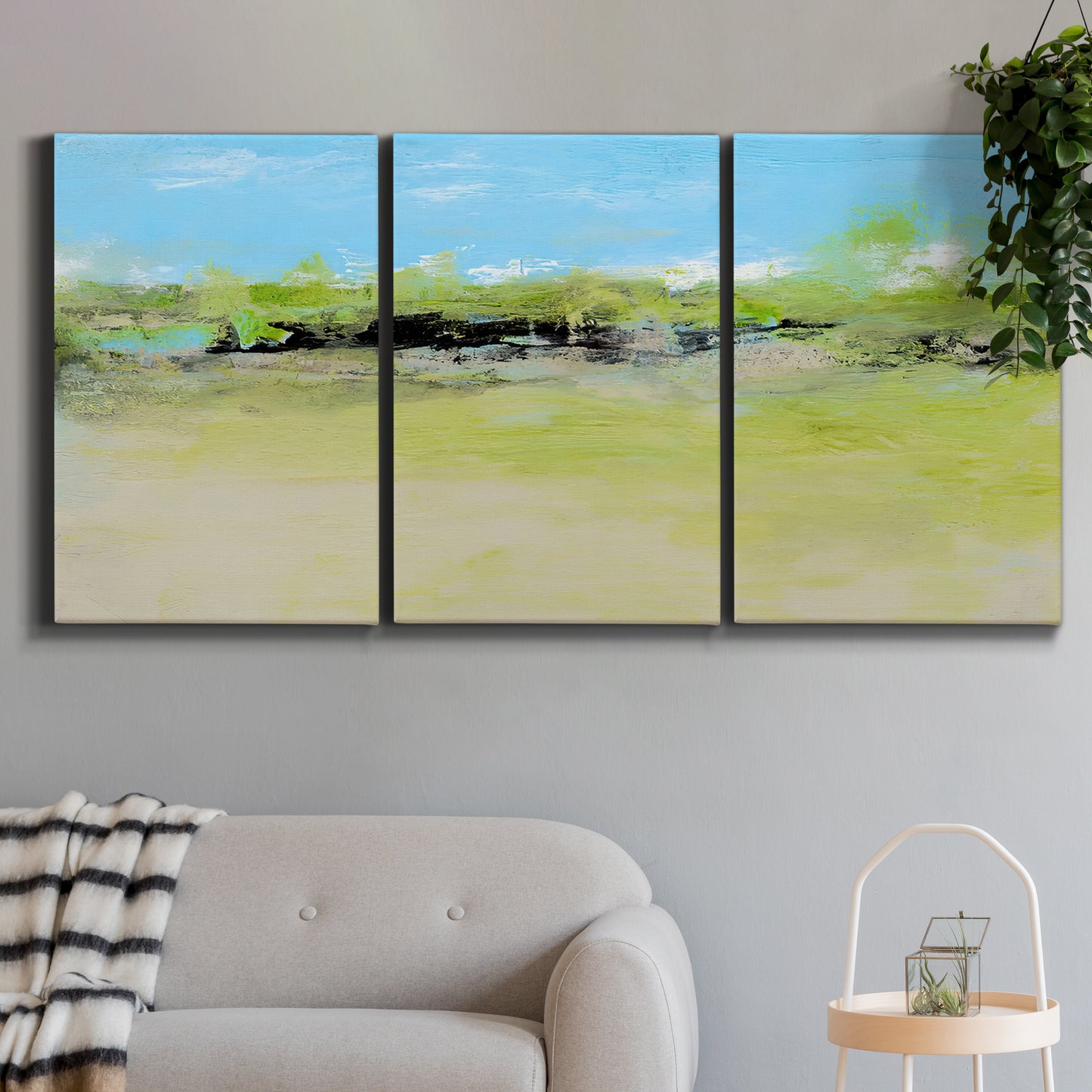 Three-panel canvas wall art featuring abstract terrace landscape view, displayed in a modern living room above a sofa.