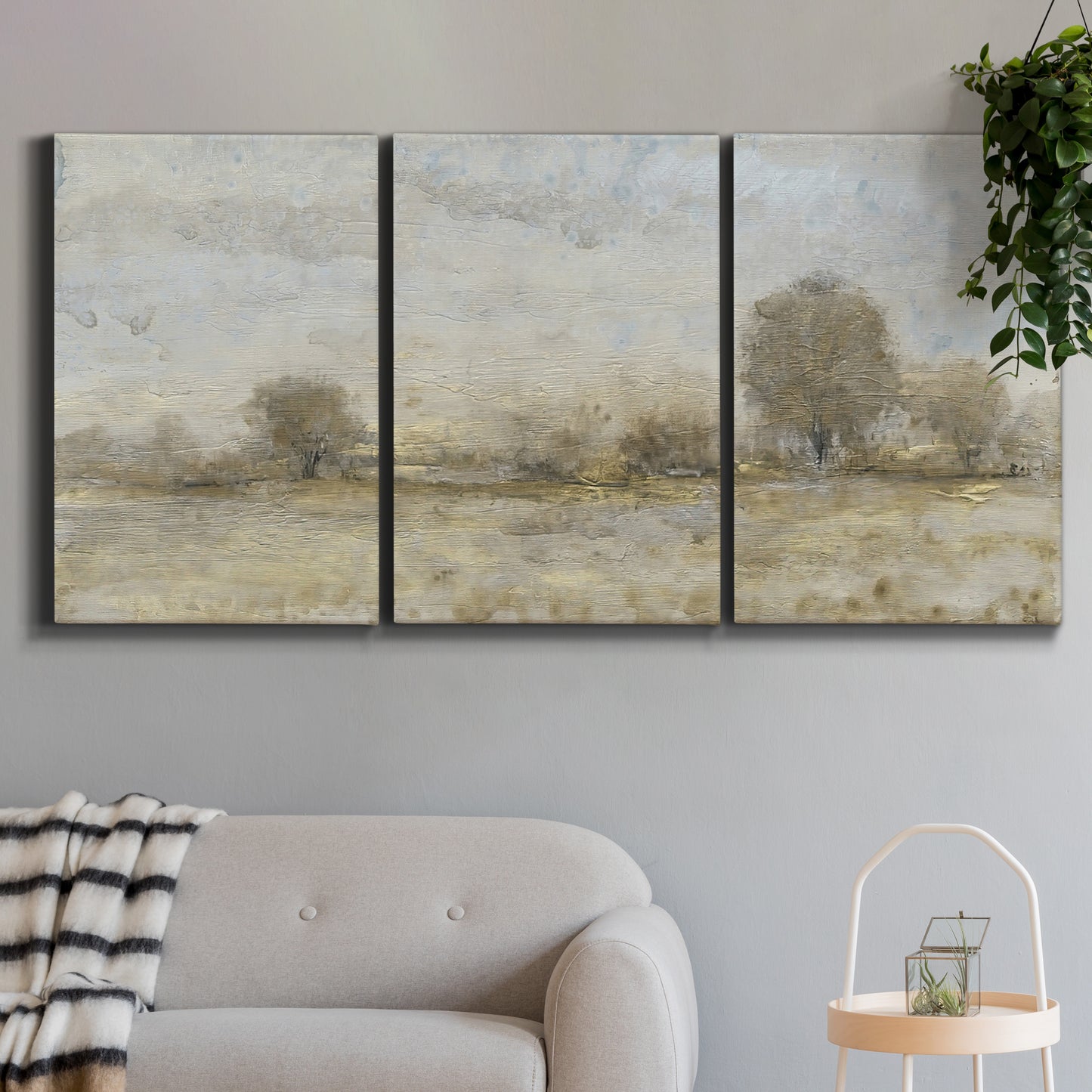 Three-panel canvas wall art featuring late season rural harvest fields, displayed in a modern living room above a sofa.