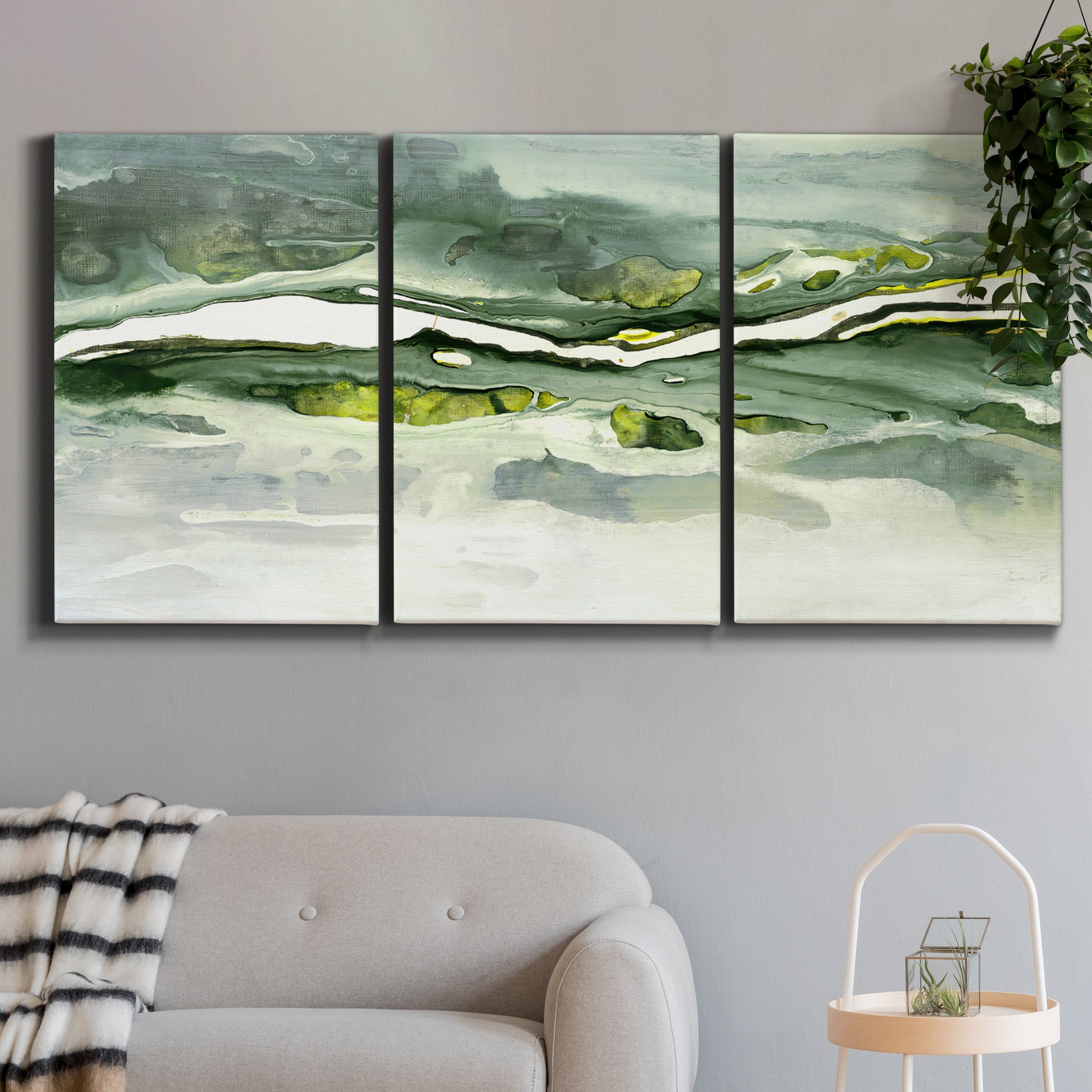Three-panel canvas wall art featuring abstract passage of time composition, displayed in a modern living room above a sofa.