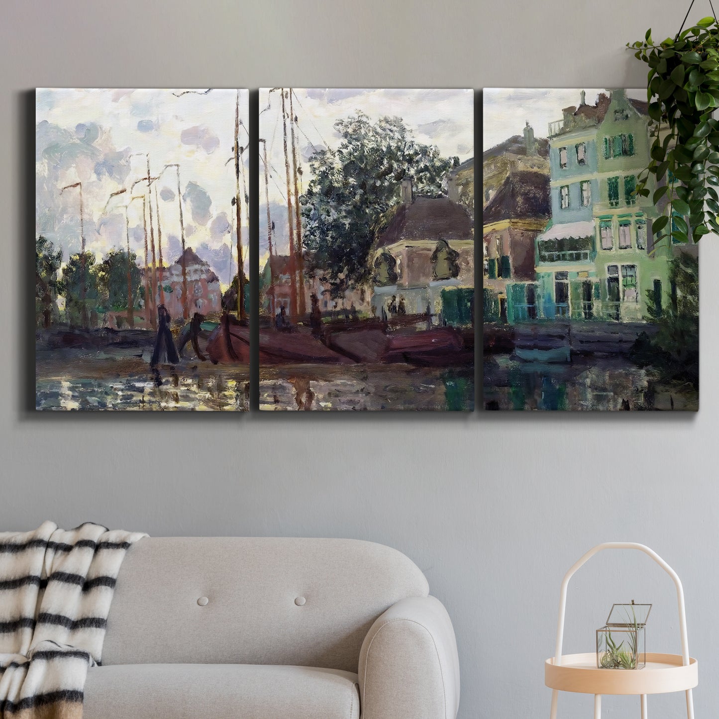 Three-panel canvas wall art featuring riverside town dike at evening, displayed in a modern living room above a sofa.