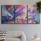 Three-panel canvas wall art featuring expressive abstract with layered color, displayed in a modern living room above a sofa.