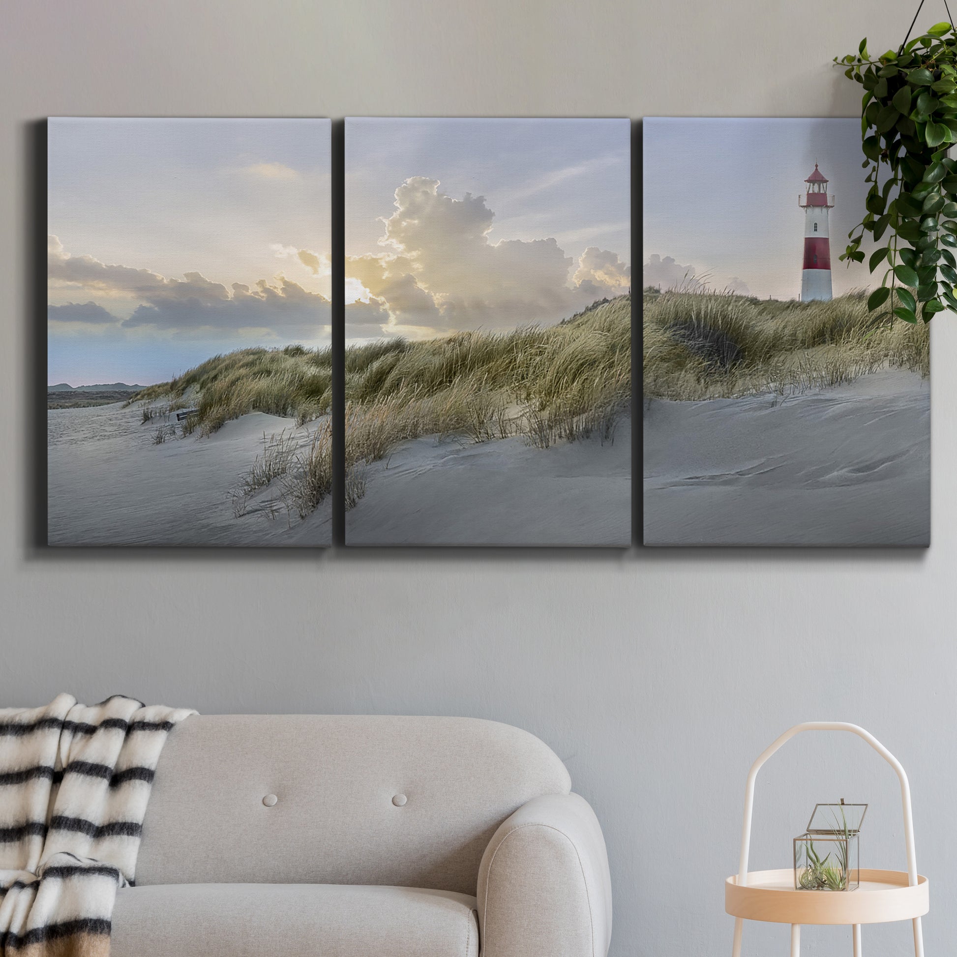 Three-panel canvas wall art featuring guardian boat along shoreline, displayed in a modern living room above a sofa.