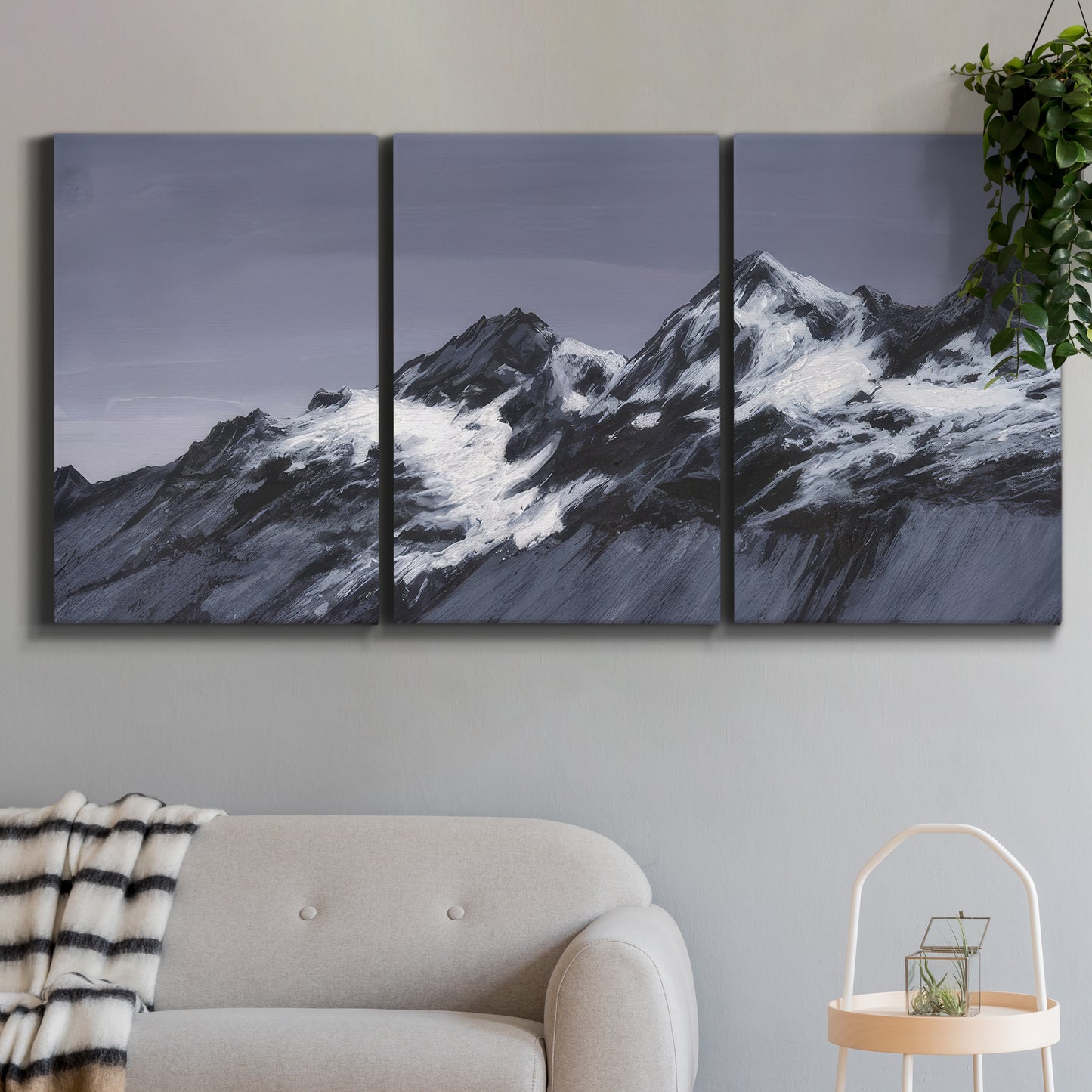 Three-panel canvas wall art featuring moonlit mountain peaks under night sky, displayed in a modern living room above a sofa.