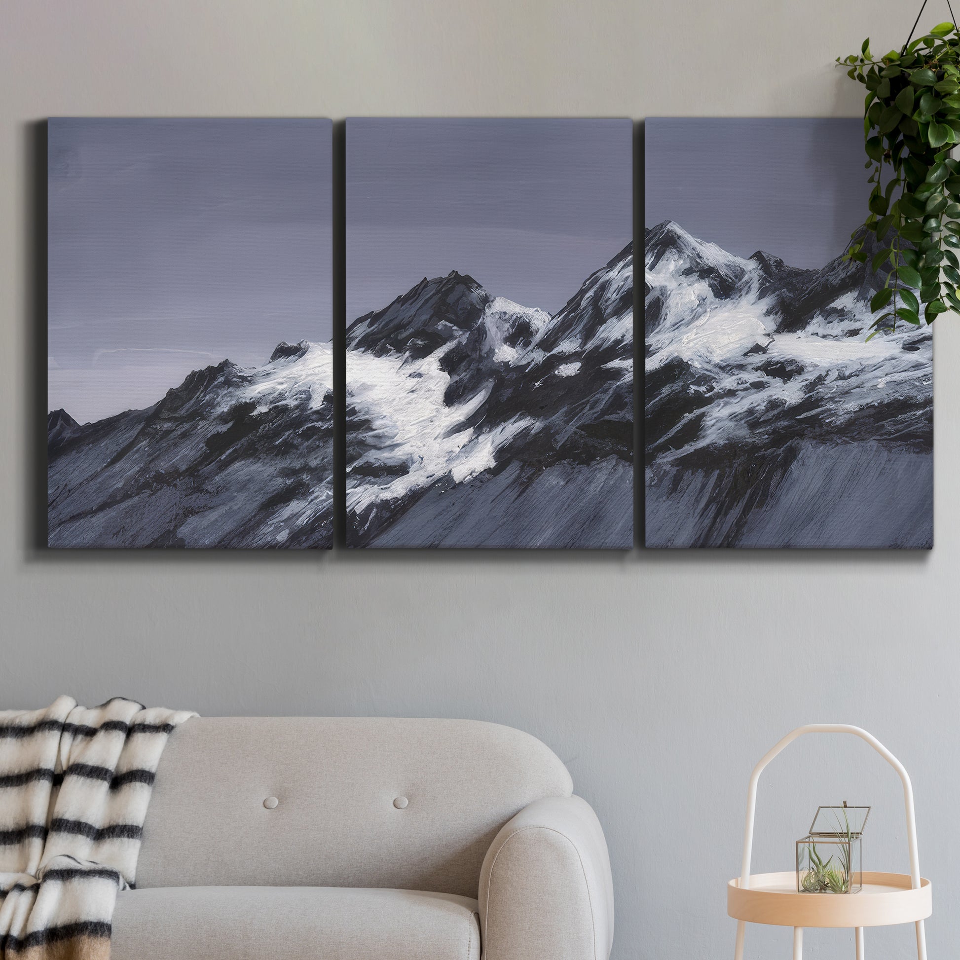 Three-panel canvas wall art featuring moonlit mountain peaks under night sky, displayed in a modern living room above a sofa.