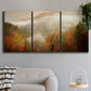 Three-panel canvas wall art featuring misty autumn landscape photograph, displayed in a modern living room above a sofa.