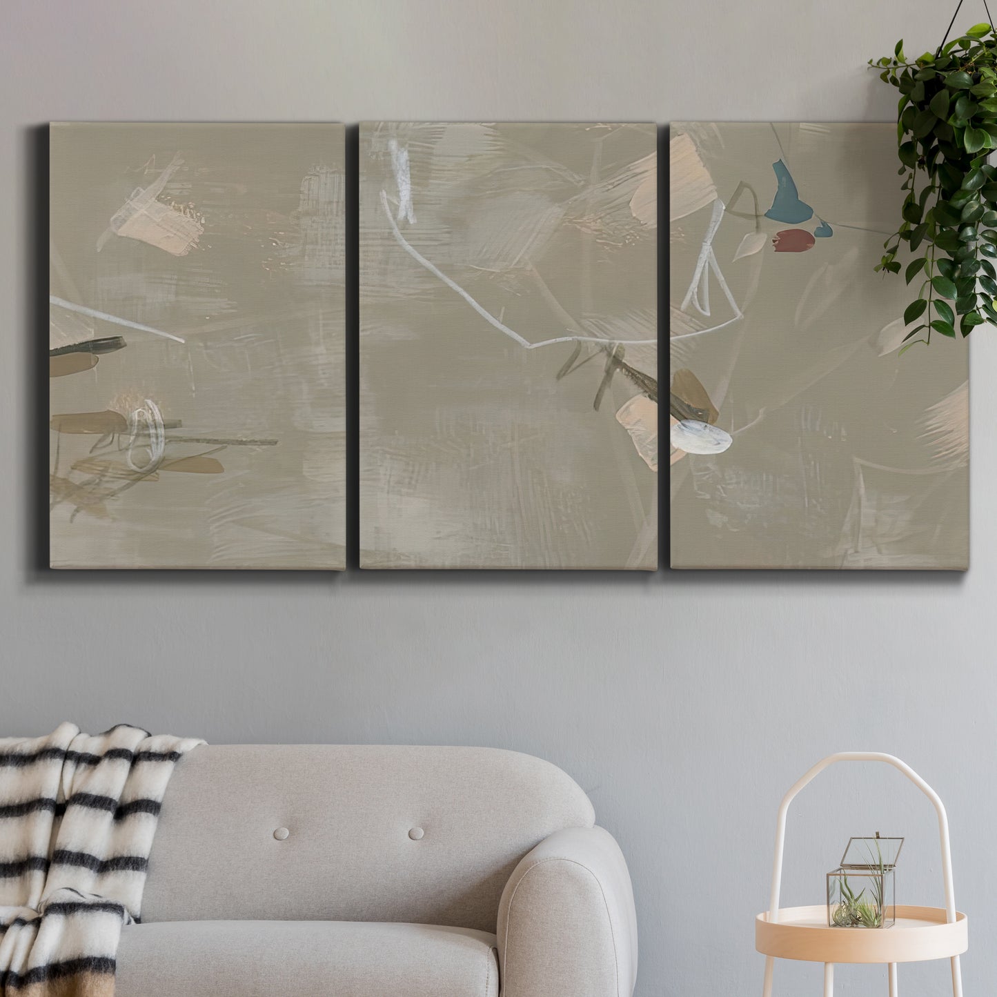 Three-panel canvas wall art featuring mid century terrazzo inspired abstraction, displayed in a modern living room above a sofa.