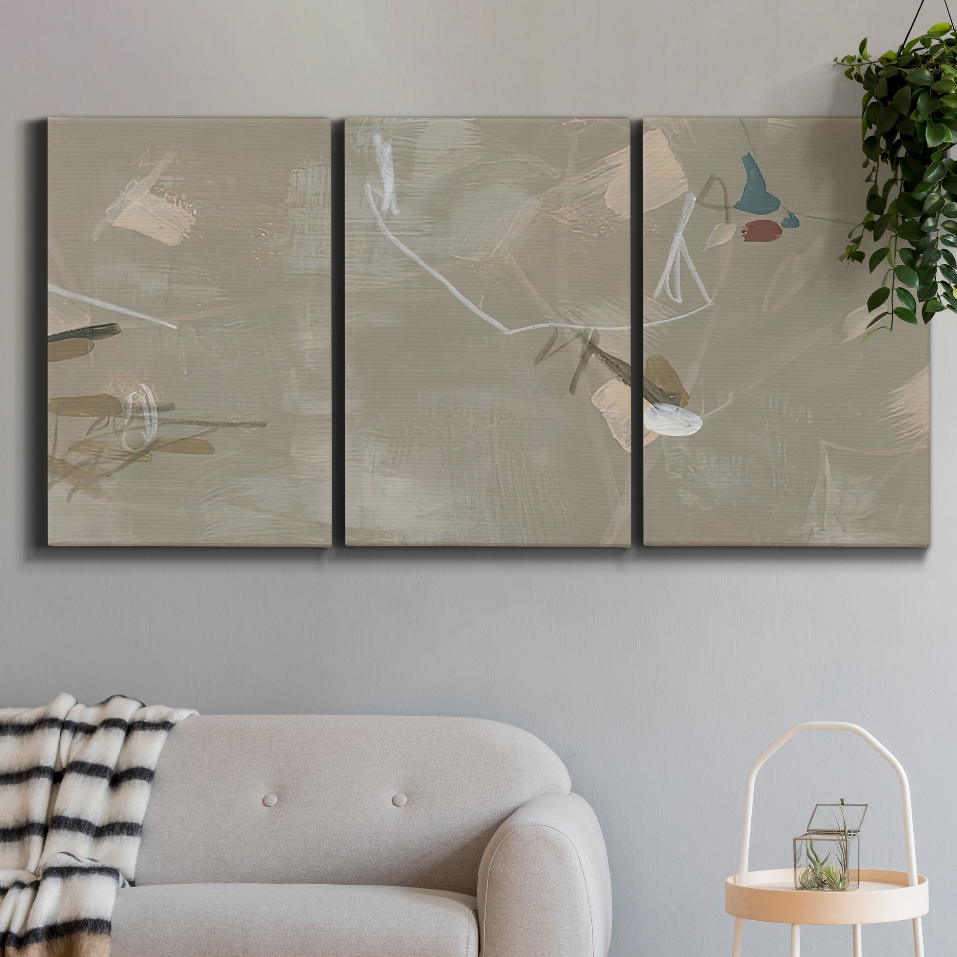 Three-panel canvas wall art featuring mid century terrazzo inspired abstraction, displayed in a modern living room above a sofa.