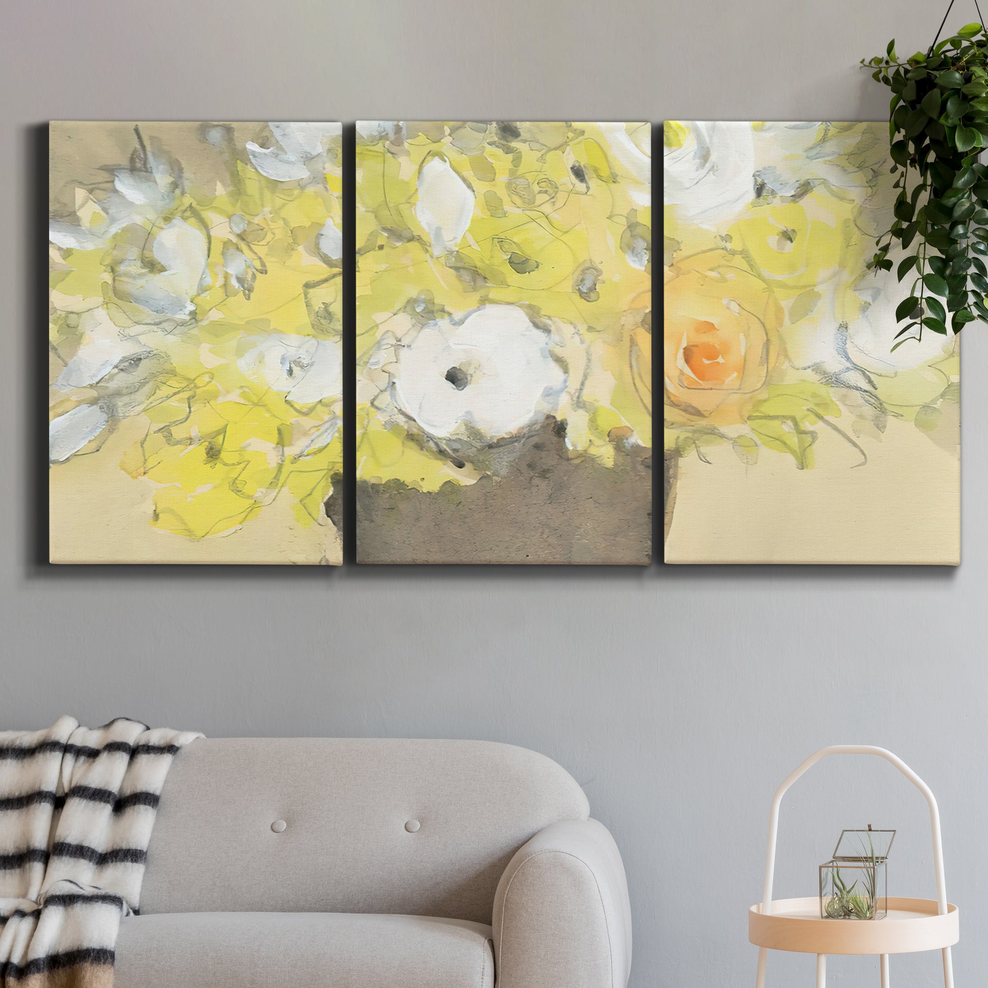 Three-panel canvas wall art featuring abstract floral table arrangement, displayed in a modern living room above a sofa.