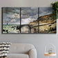 Three-panel canvas wall art featuring sunset beach with glowing sky, displayed in a modern living room above a sofa.