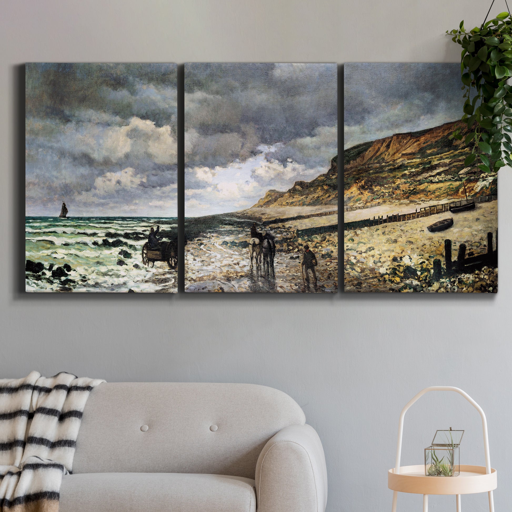 Three-panel canvas wall art featuring sunset beach with glowing sky, displayed in a modern living room above a sofa.