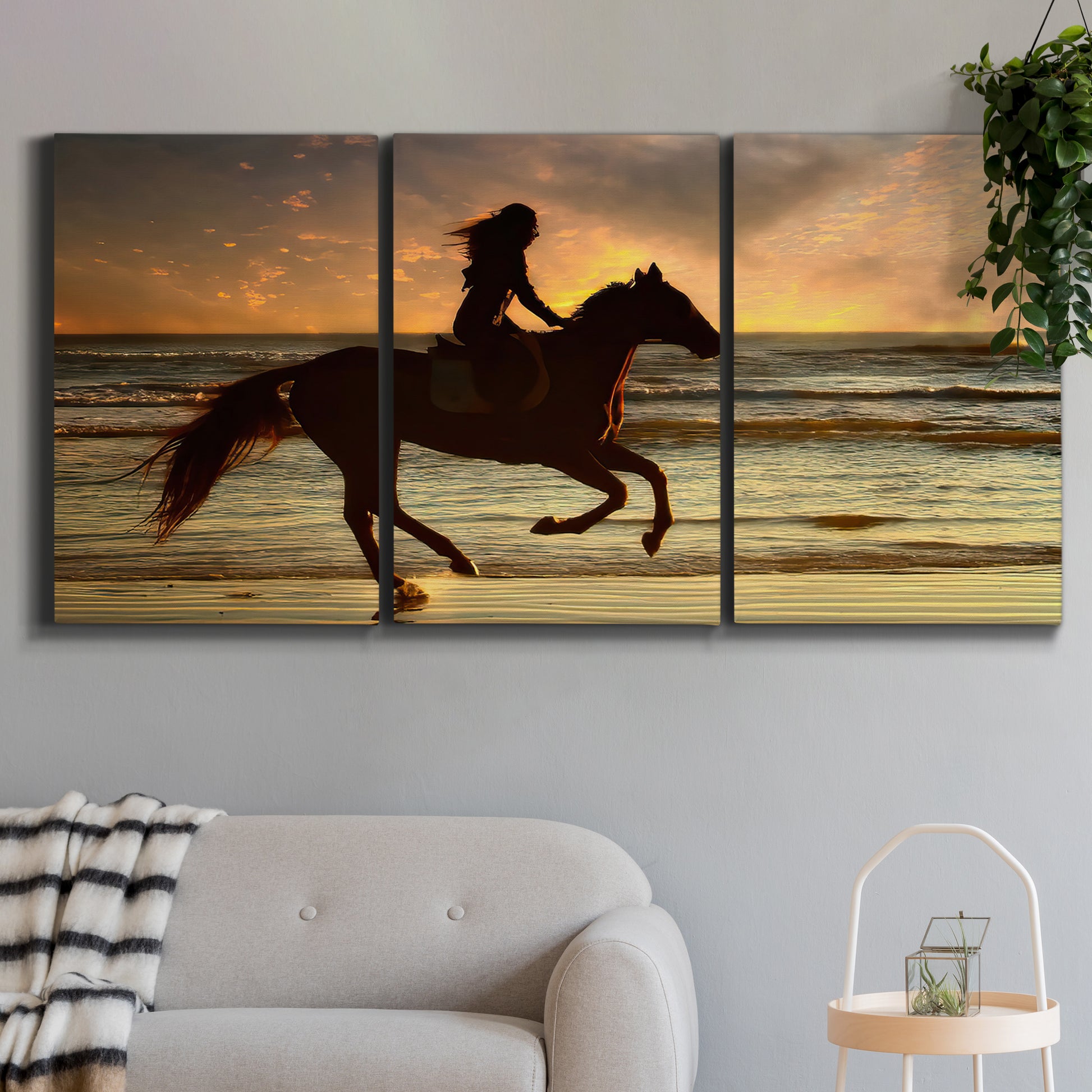 Three-panel canvas wall art featuring running horse along beach photograph, displayed in a modern living room above a sofa.
