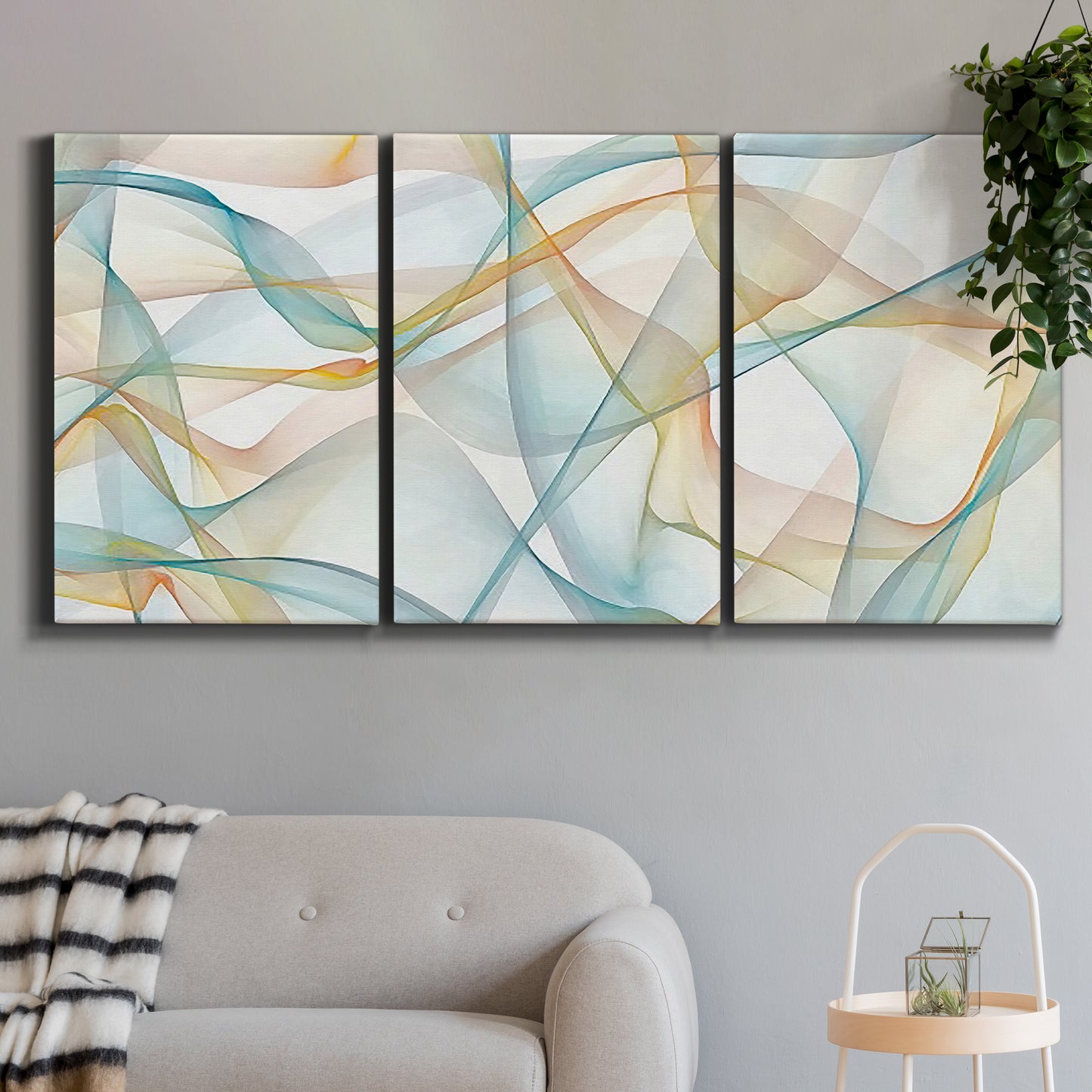 Three-panel canvas wall art featuring flowing abstract curves and wave patterns, displayed in a modern living room above a sofa.