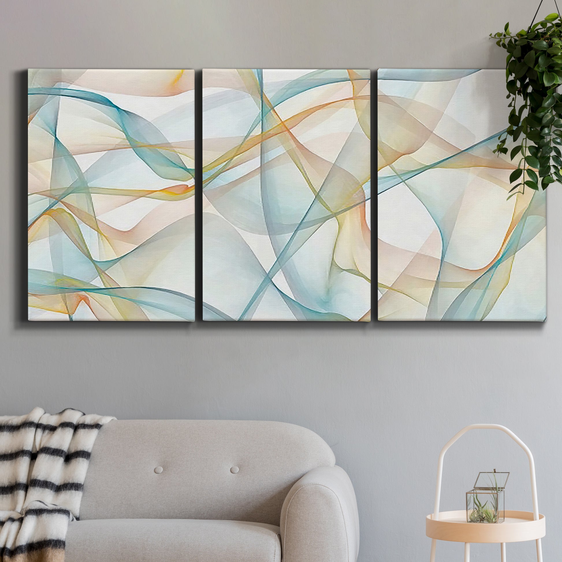 Three-panel canvas wall art featuring flowing abstract curves and wave patterns, displayed in a modern living room above a sofa.