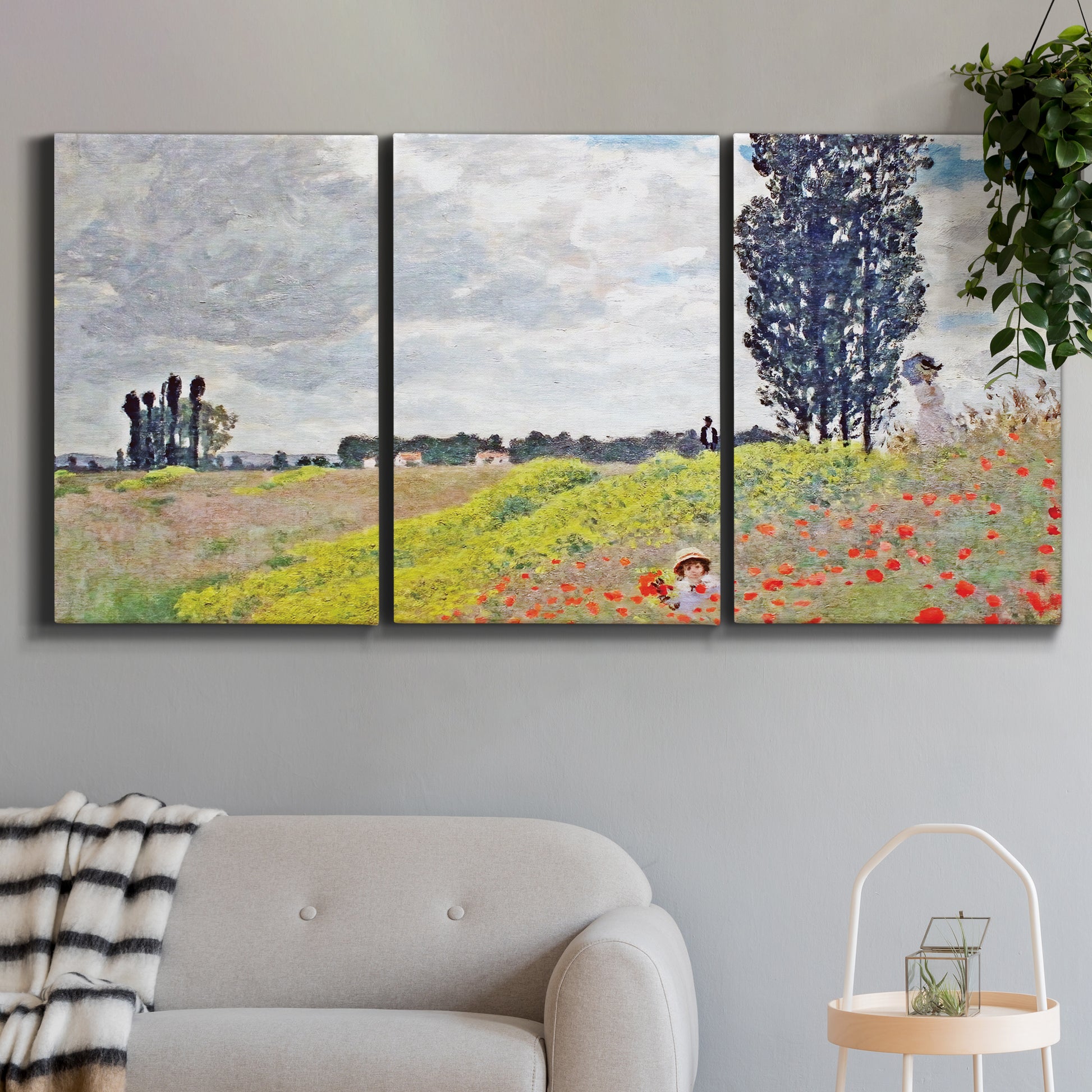 Three-panel canvas wall art featuring open poppy field in countryside, displayed in a modern living room above a sofa.