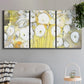 Three-panel canvas wall art featuring vintage inspired floral abstraction, displayed in a modern living room above a sofa.