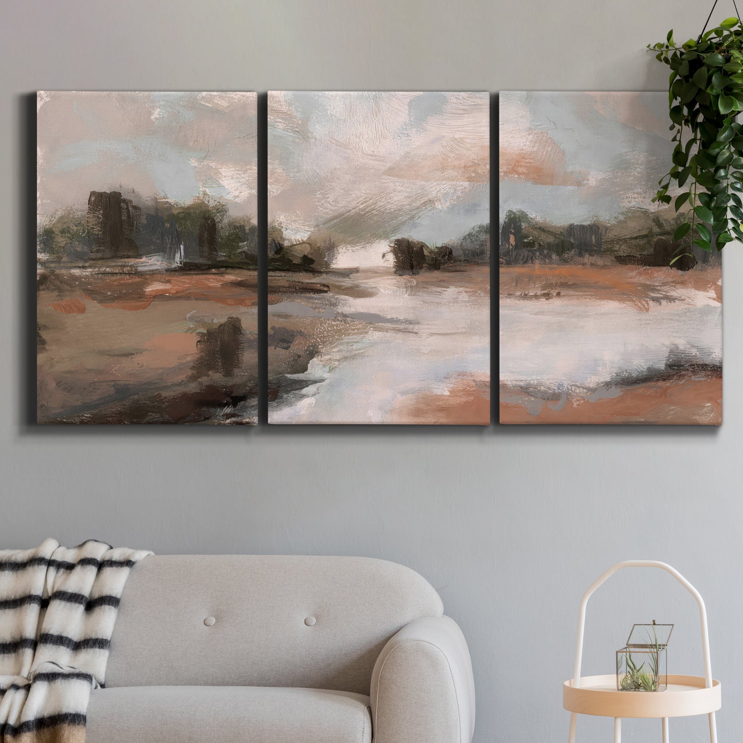 Three-panel canvas wall art featuring quiet pond with soft reflections, displayed in a modern living room above a sofa.