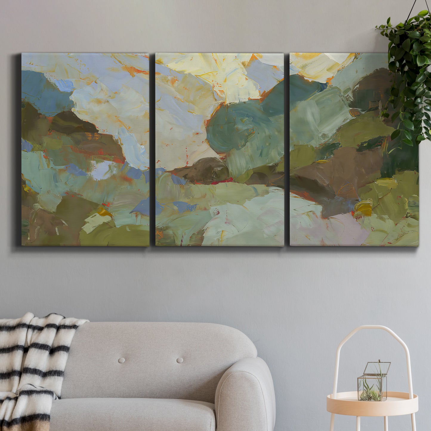 Three-panel canvas wall art featuring abstract landscape suggesting travel pause, displayed in a modern living room above a sofa.
