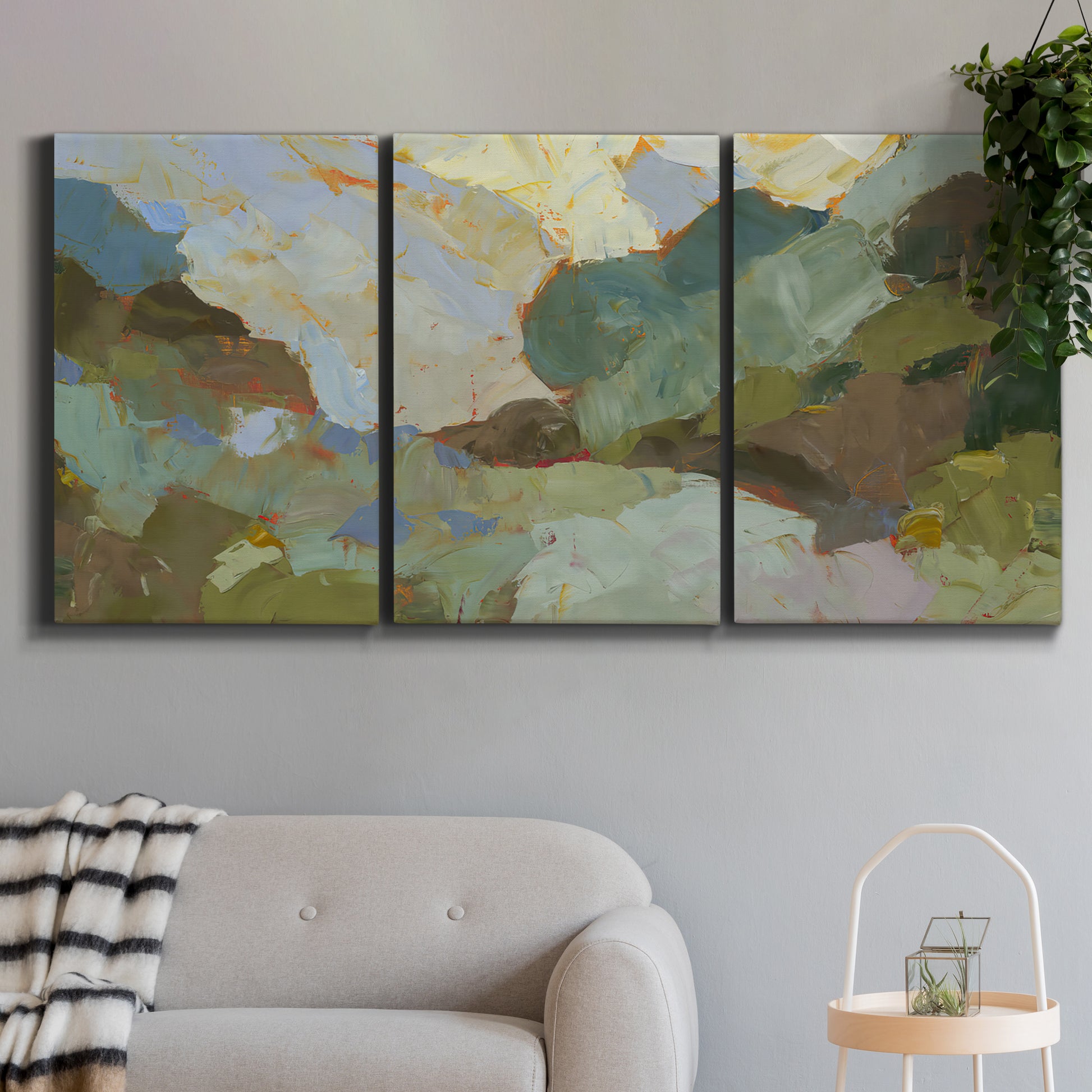 Three-panel canvas wall art featuring abstract landscape suggesting travel pause, displayed in a modern living room above a sofa.