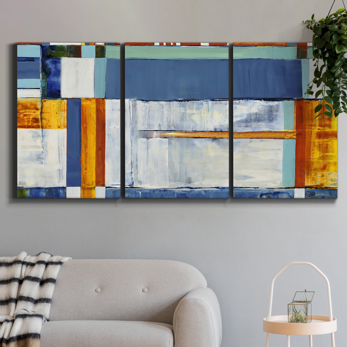 Three-panel canvas wall art featuring bright mid century geometric abstraction, displayed in a modern living room above a sofa.