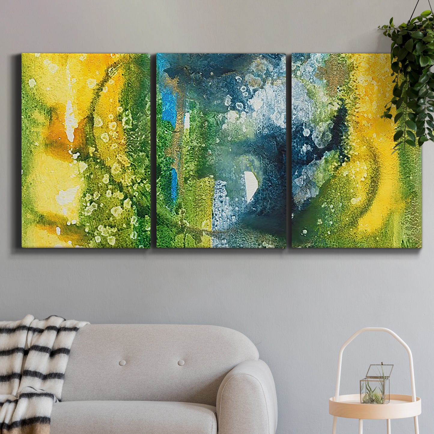 Three-panel canvas wall art featuring energetic abstract aquatic color motion, displayed in a modern living room above a sofa.