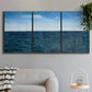 Three-panel canvas wall art featuring open water landscape with wide horizon, displayed in a modern living room above a sofa.